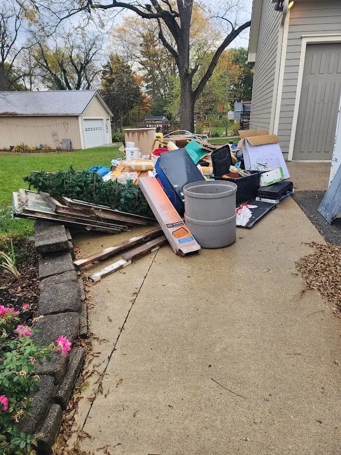 Dumpster being loaded with debris for Demolition Dumpster Rental in Pine Ridge
